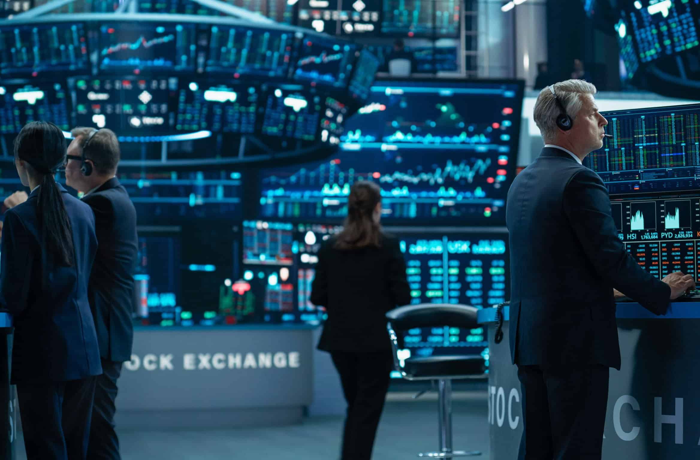 Tech financial trading floor with professionals analyzing stock market data.